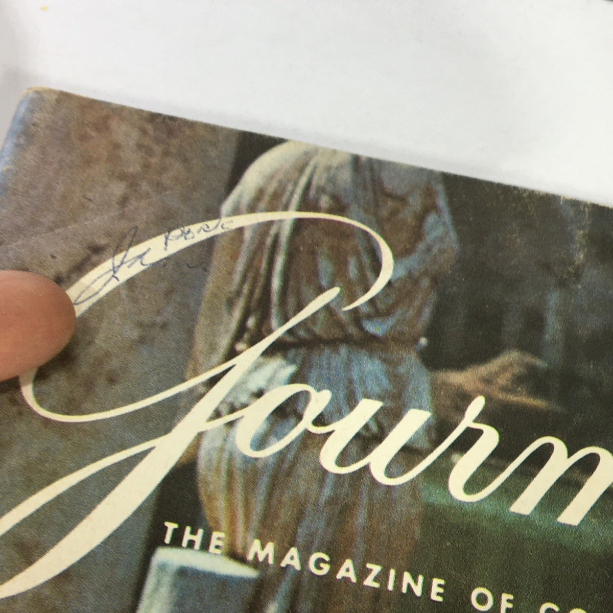 Close-up of the cover of VTG Gourmet Magazine May 1969 titled 'A Feast in Bengal', featuring a handwritten signature and design details.