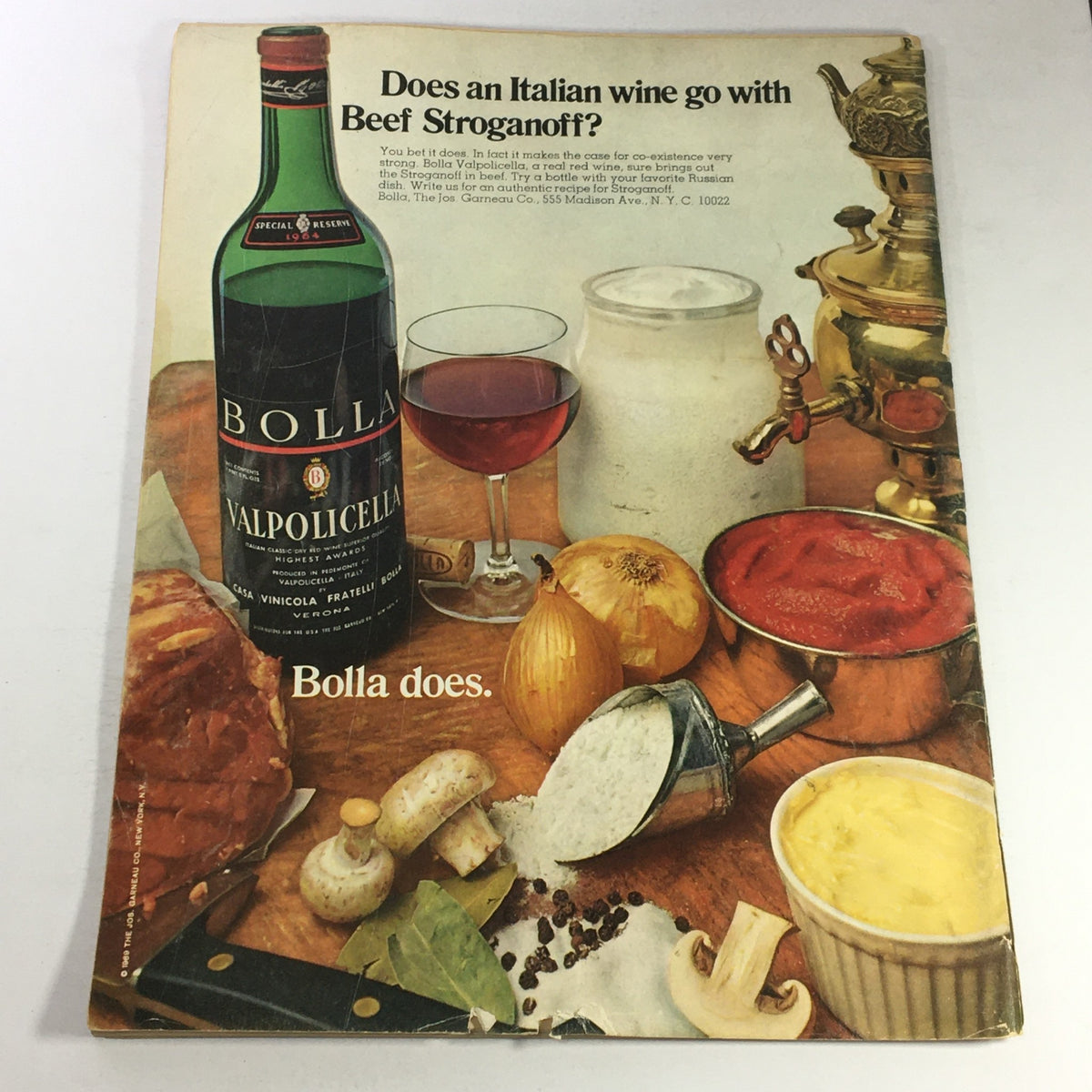 Cover of VTG Gourmet The Magazine of Good Living February 1970 featuring a vibrant food scene. The image showcases a bottle of Bolla Valpolicella wine alongside ingredients for Beef Stroganoff, including a glass of red wine, mushrooms, spices, onions, and cream. Perfect for collectors and food enthusiasts interested in vintage culinary publications.