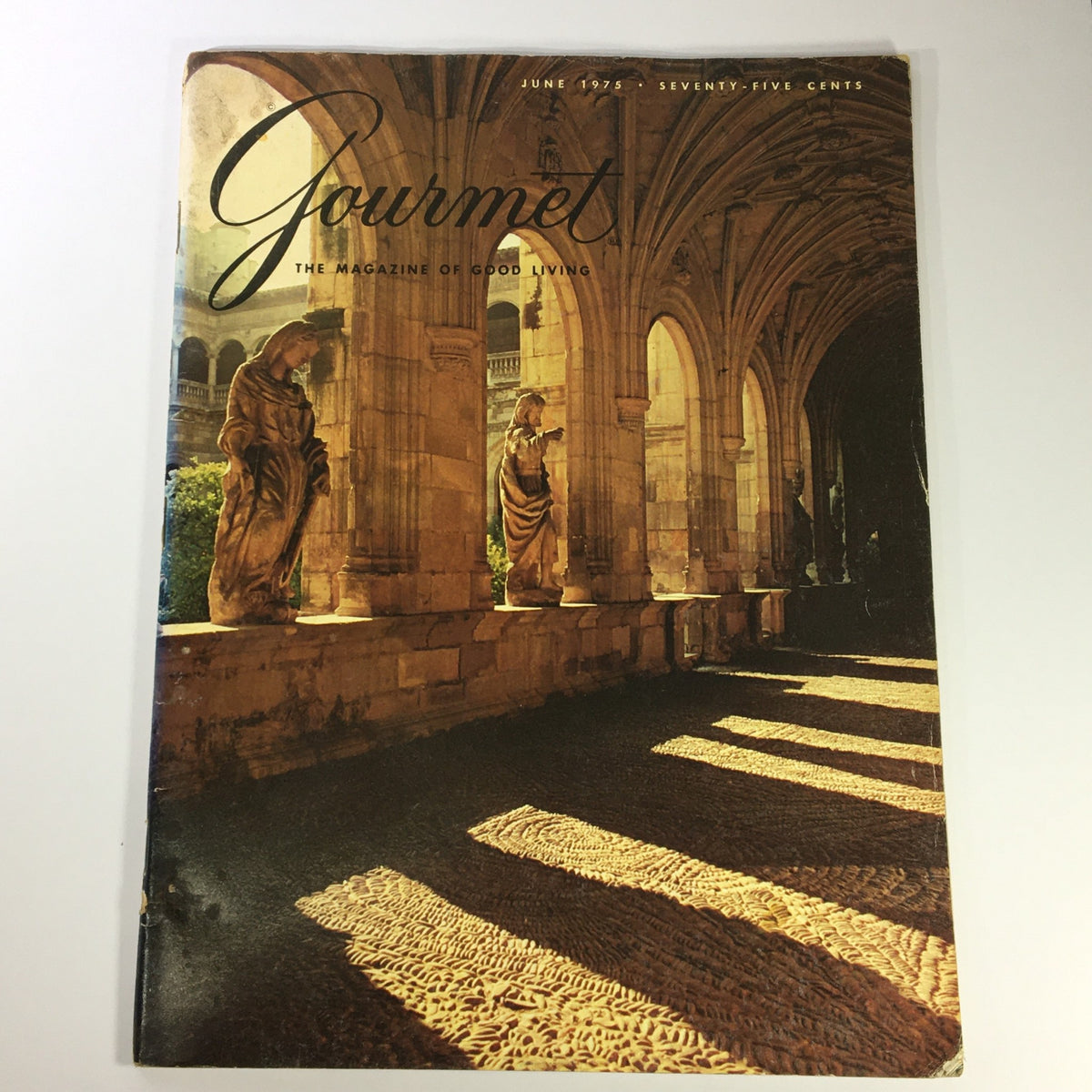 Cover of VTG Gourmet: The Magazine of Good Living from June 1975 featuring an architectural view with shadows on the ground and statues.