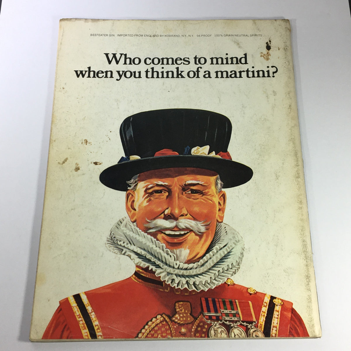 Back cover of VTG Gourmet: The Magazine of Good Living featuring an illustration of a smiling gentleman in a hat, promoting Beefeater Gin.