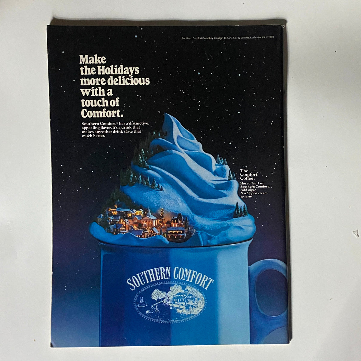 Inside Sports Magazine December 1990 advertisement page for Southern Comfort, featuring a holiday-themed drink and the slogan 'Make the Holidays more delicious with a touch of Comfort'.