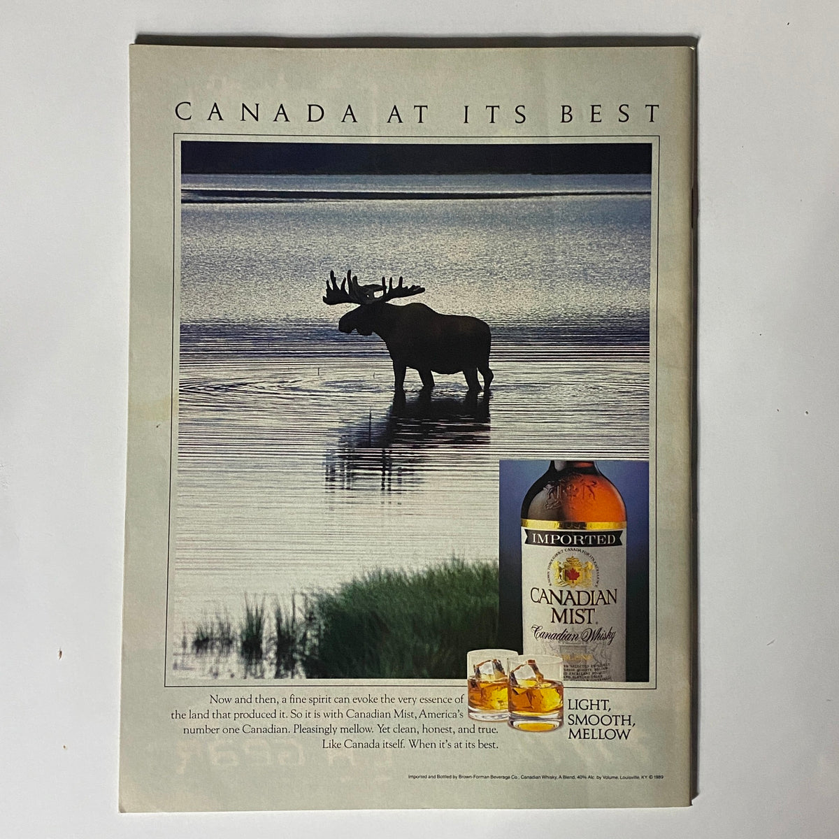 Advertisement from Inside Sports Magazine, featuring a Canadian Mist whisky ad with a scenic background of a moose by water. This page highlights the Canadian scenery while promoting Canadian Mist as a premium whisky.