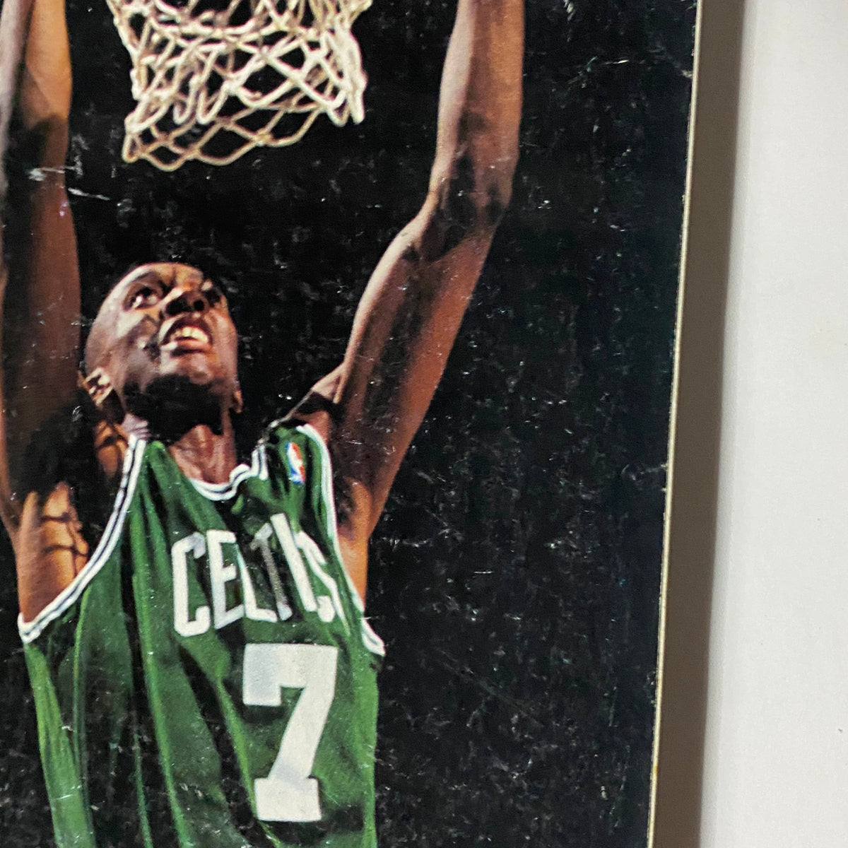 Close-up view of Dee Brown on the cover of Street & Smith's Pro Basketball Magazine 1994-1995, highlighting his expression during a dunk.