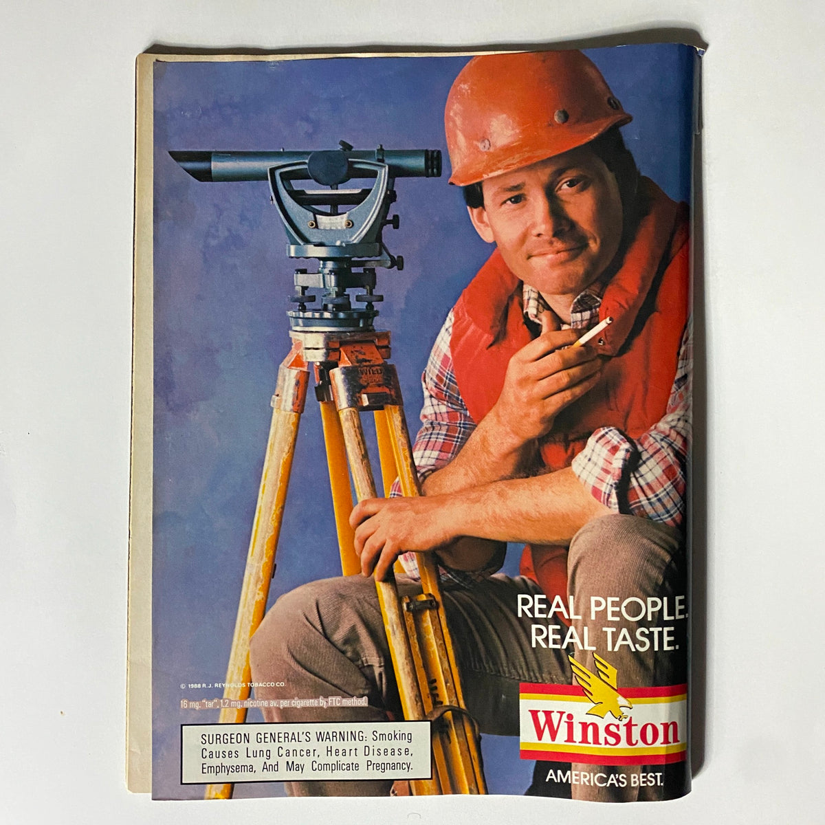 Advertisement page from VTG Sport Magazine November 1988 promoting Winston cigarettes, featuring a man with a leveling instrument.
