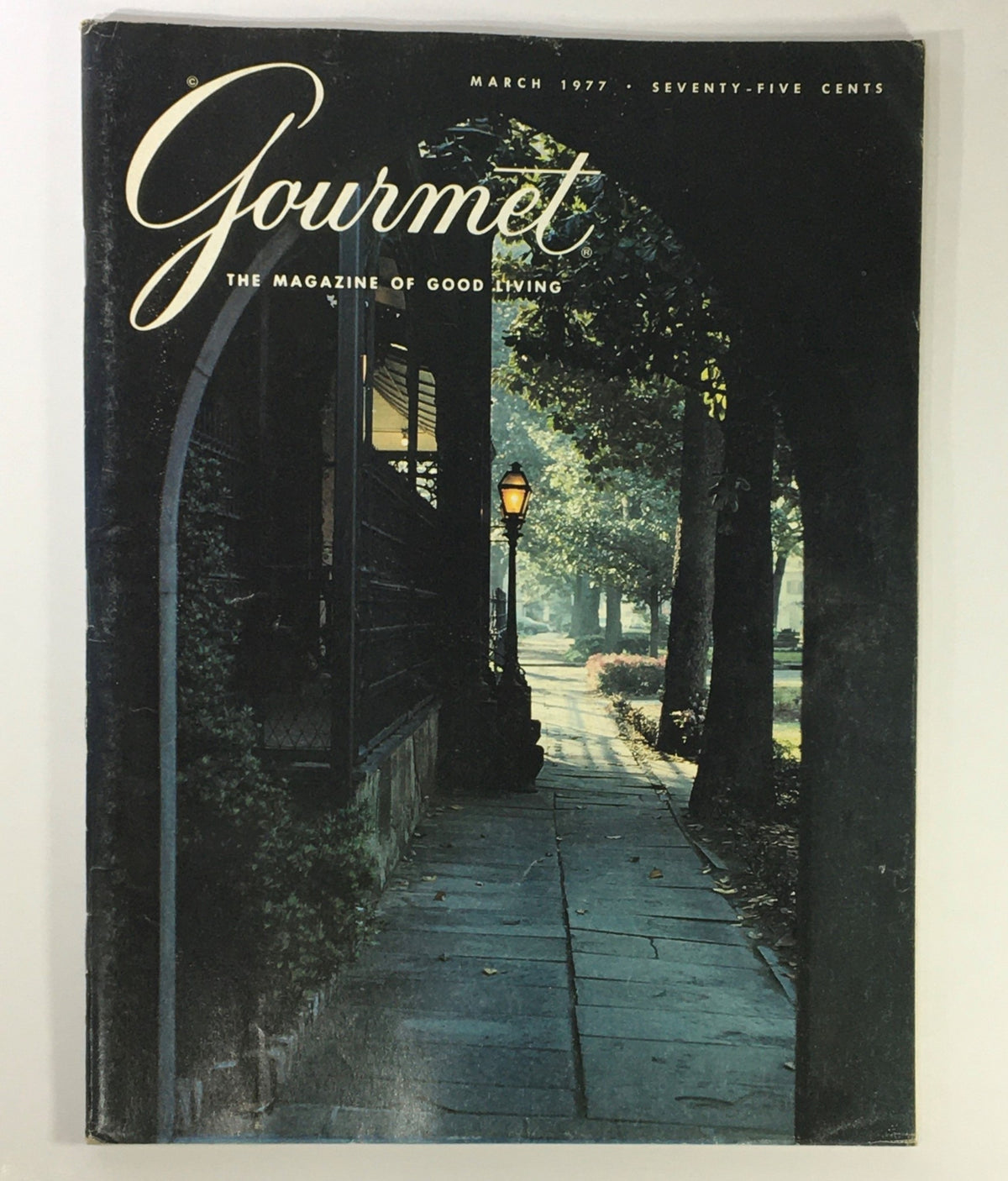 Cover of VTG Gourmet The Magazine of Good Living March 1977 featuring a serene pathway with trees and a lamp, highlighting the theme 'Iran Beyond Tehran'.