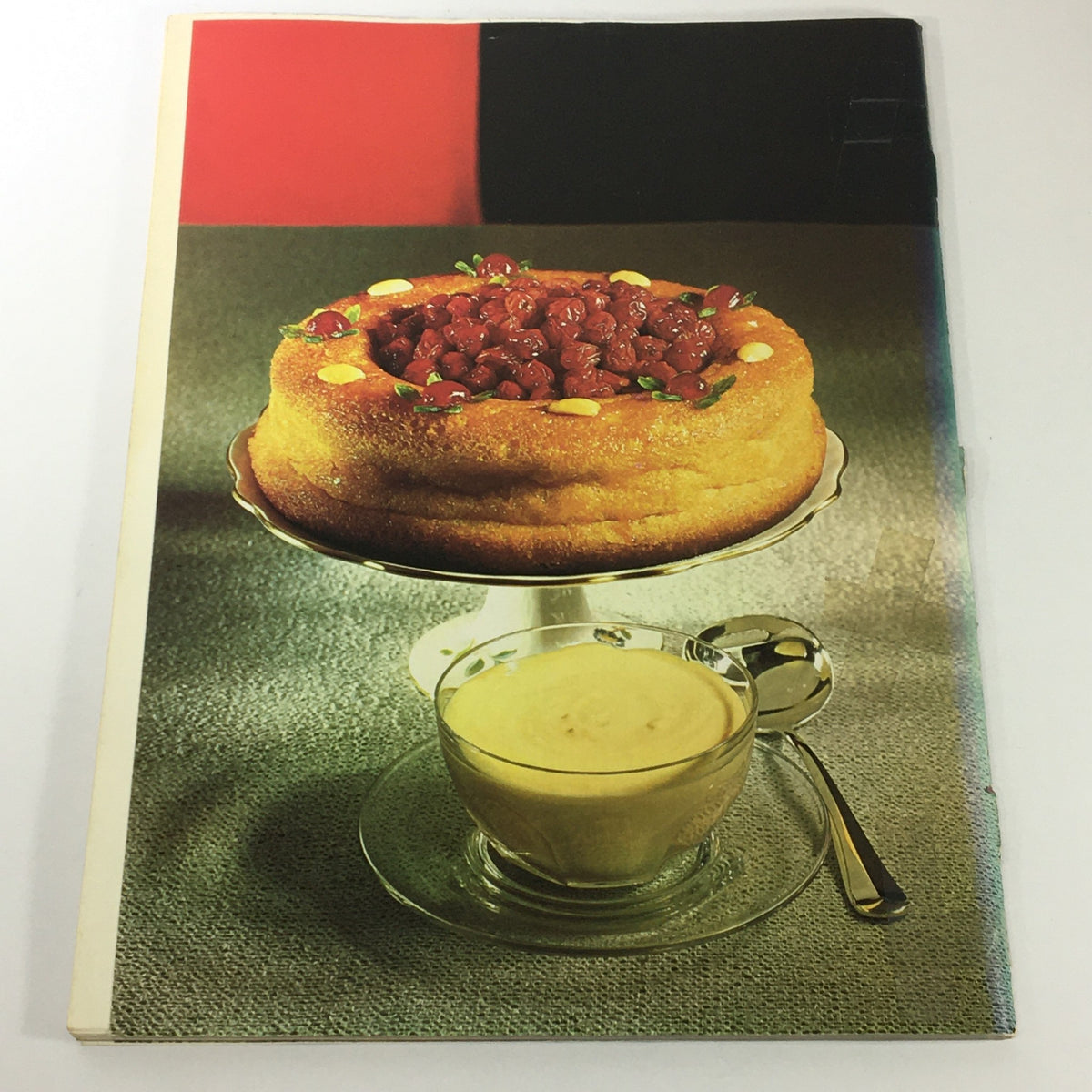 Back cover of VTG Gourmet December 1971, featuring an elegant cake and custard presentation, emphasizing holiday culinary traditions.