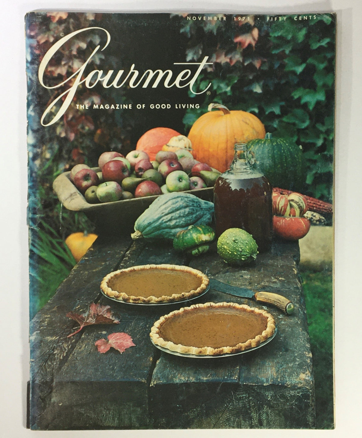 Cover of VTG Gourmet: The Magazine of Good Living November 1971 featuring a rustic table with two pies, an assortment of fruits, and autumn vegetables, capturing the essence of gourmet cooking and gluten-free baking.