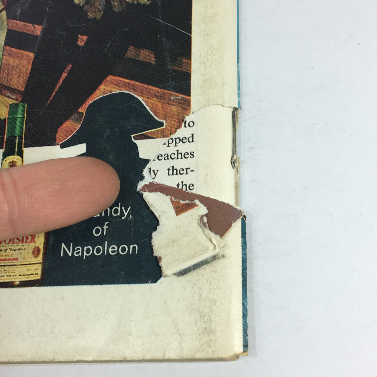 Close-up of the damaged edge of the November 1971 issue of VTG Gourmet: The Magazine of Good Living, featuring torn cover and visible wear, reflecting the vintage quality of this collectible magazine.