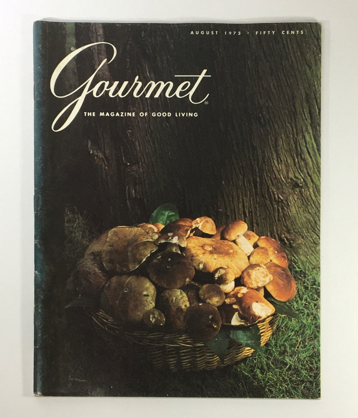 Cover of VTG Gourmet: The Magazine of Good Living, August 1973, featuring a basket of mushrooms against a textured wooden background. An illustration of culinary elegance and the 1970s dining culture.