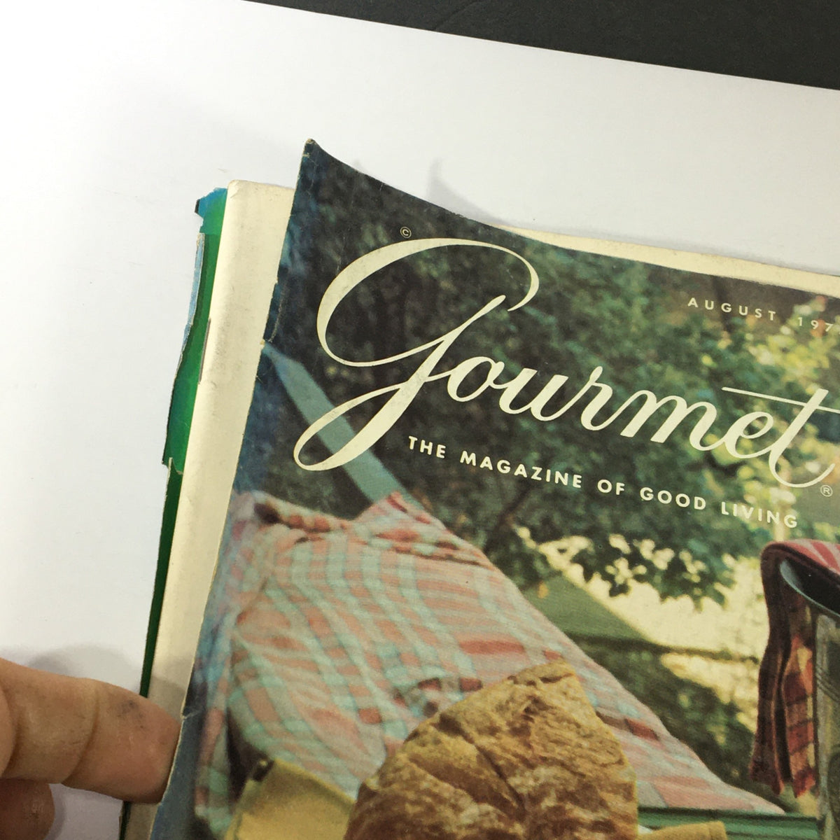Close-up view of the cover of VTG Gourmet The Magazine of Good Living August 1975 featuring the publication's title and a bread roll.