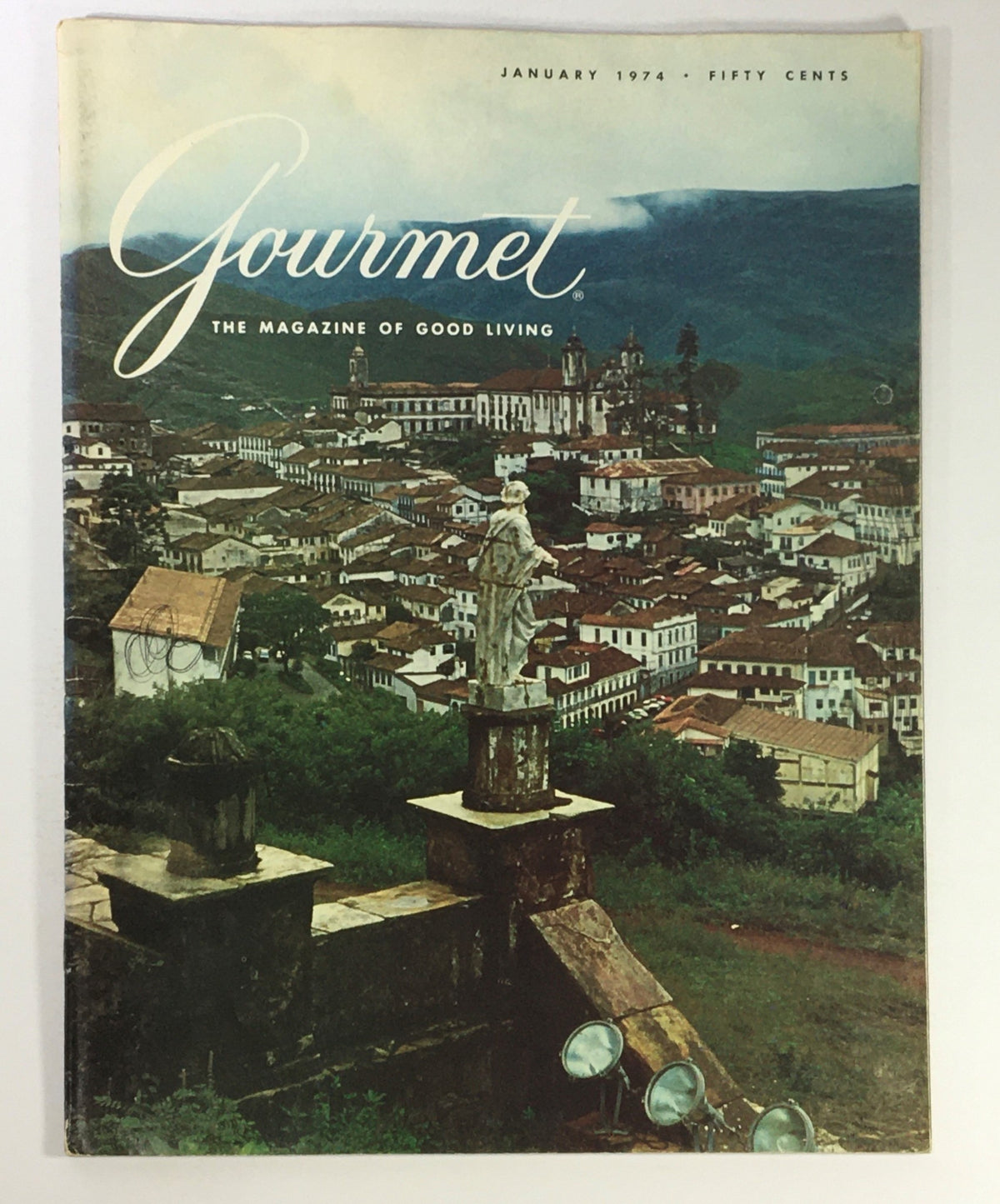 Cover of VTG Gourmet The Magazine of Good Living January 1974, featuring a scenic view of a town with historical architecture and a statue.