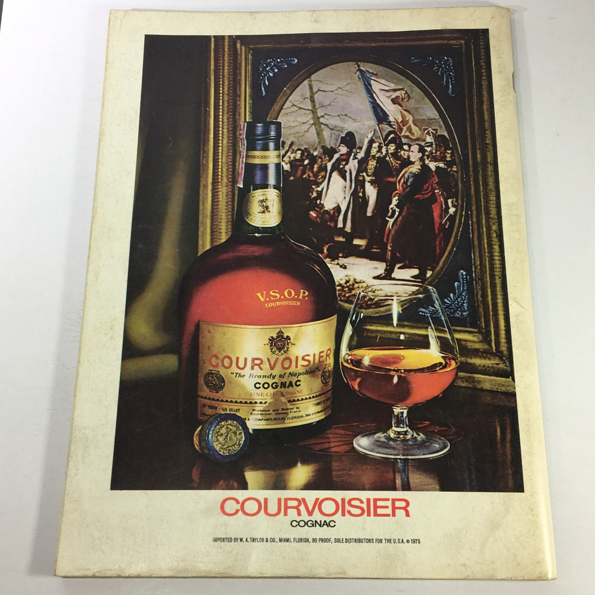 Cover of VTG Gourmet The Magazine of Good Living November 1975 featuring Courvoisier Cognac, showcasing a bottle beside a glass filled with cognac, and a background of historical figures in a painting.