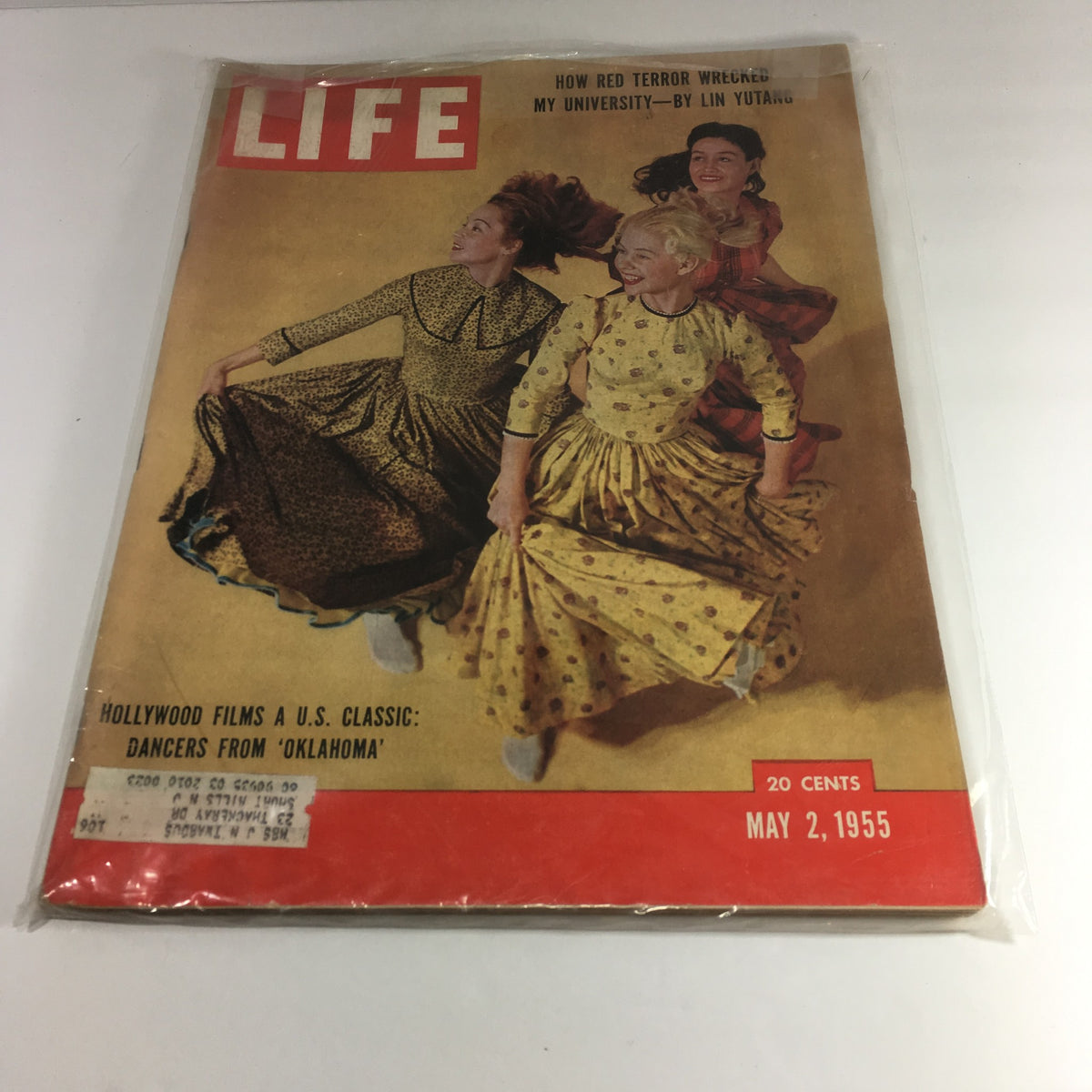 Cover of Life Magazine from May 2, 1955, featuring dancers from 'Oklahoma,' showcasing vibrant costumes and lively performances. This issue celebrates Hollywood films as a U.S classic.