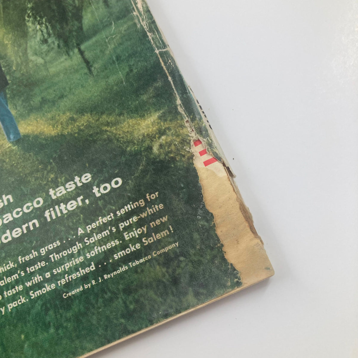 Close-up of the damaged edge of VTG True Story Magazine May 1959, featuring visible wear and creases on the cover, characteristic of vintage magazines.