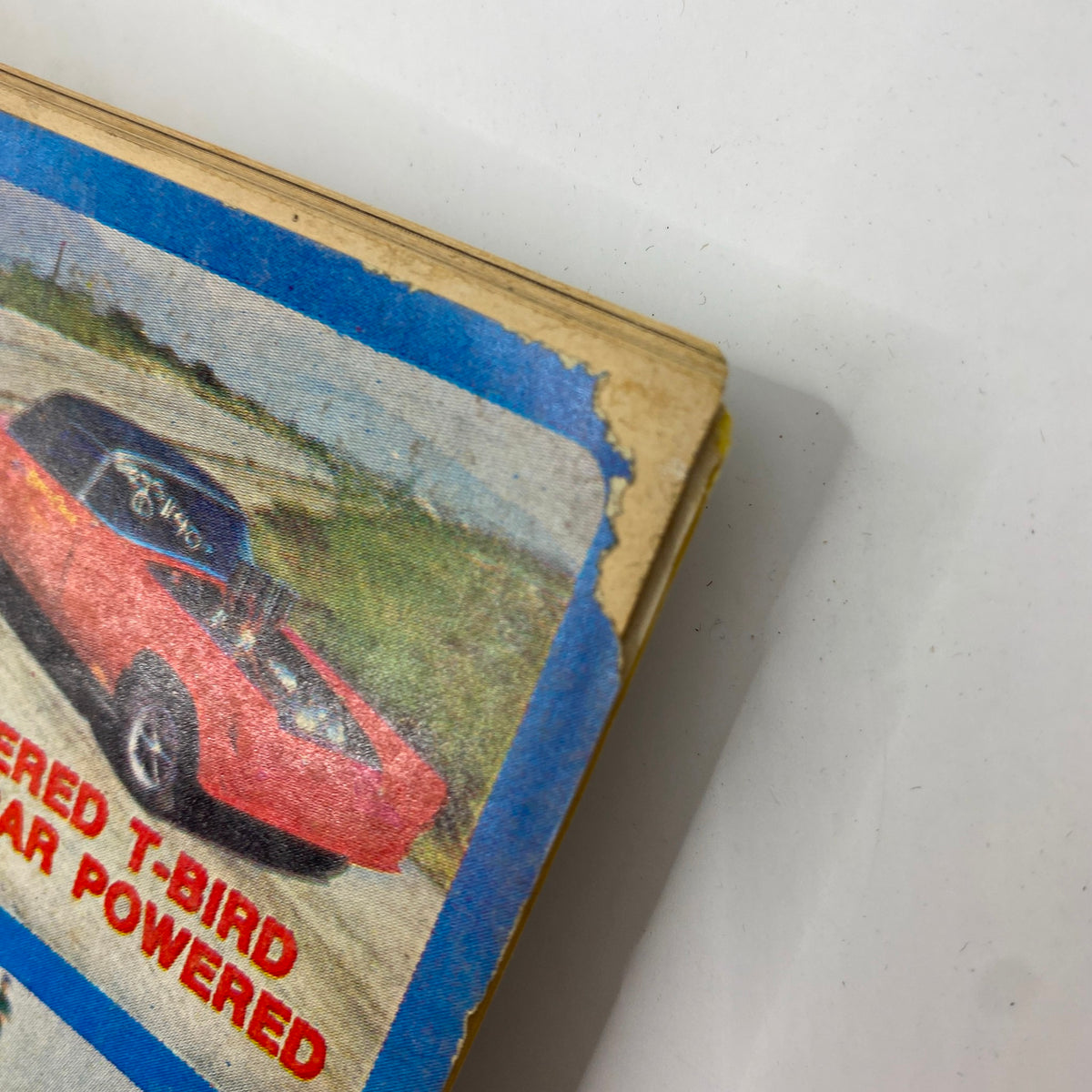 Close-up view of the edge of the September 1968 American Rodding Magazine, featuring a vintage design and highlighting Carroll Shelby and a drag racing T-bird.