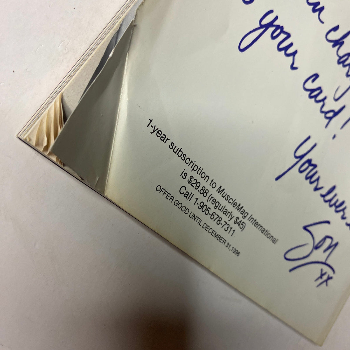 Close-up of the back cover of MuscleMag International Magazine February 1997 featuring a subscription offer and handwritten note. This vintage bodybuilding magazine features Mike O'Hearn and Amy Fadhli on the cover.