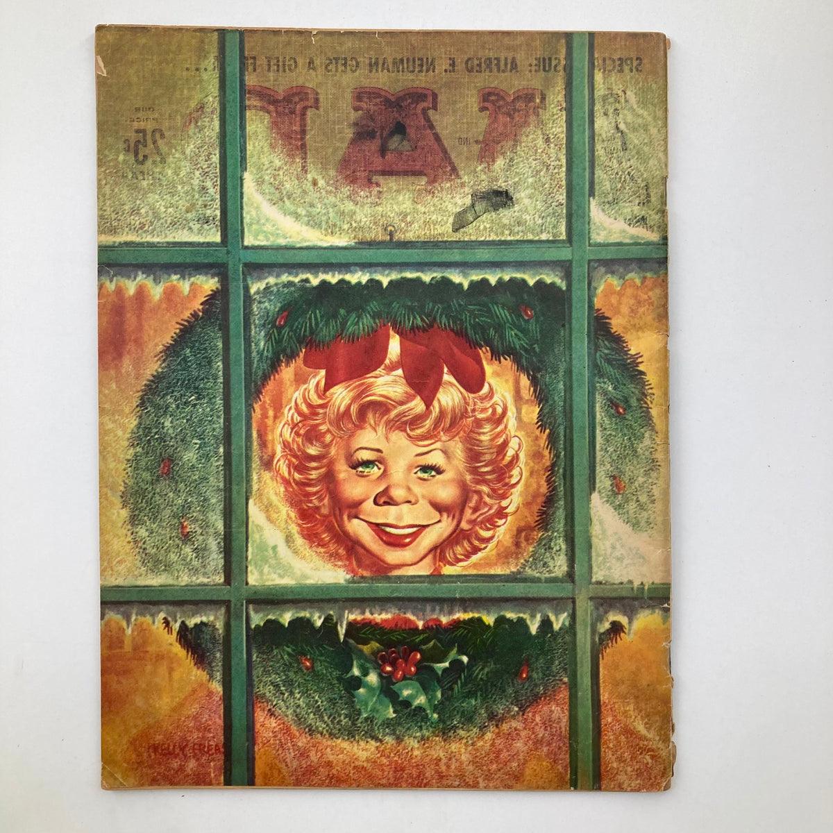 Back cover of Mad Magazine January 1959 No. 44 featuring a smiling woman looking through a window decorated with a wreath, emphasizing the magazine's playful holiday spirit.