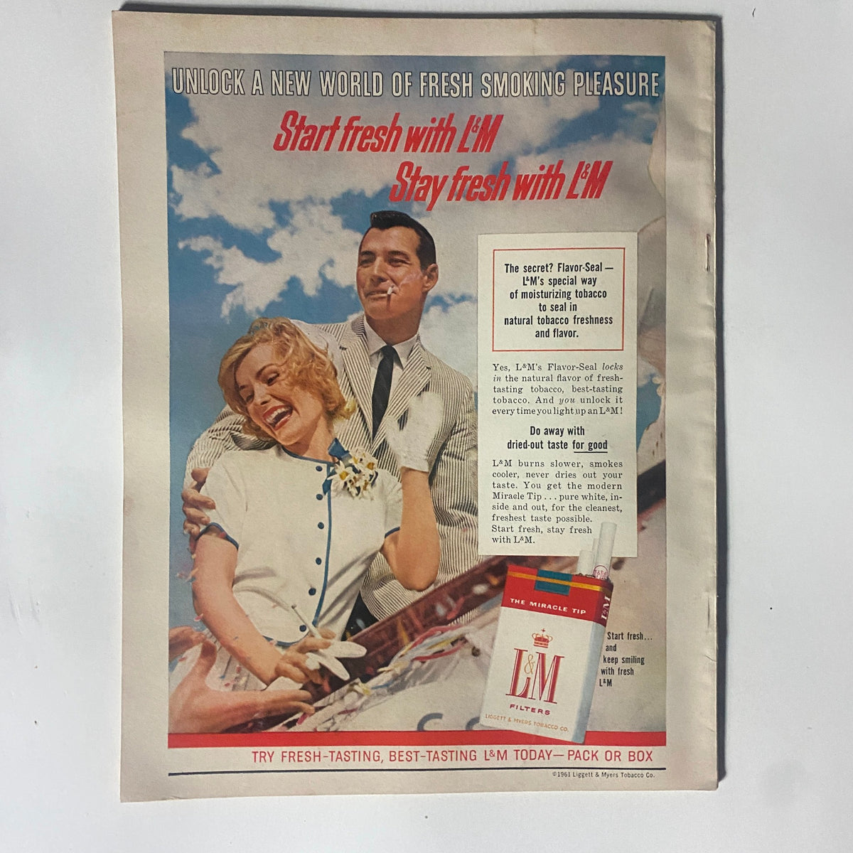 Advertisement page in VTG Motor Trend Magazine September 1961, featuring a vintage ad for L&M Filters with a smiling couple, emphasizing fresh smoking pleasure.