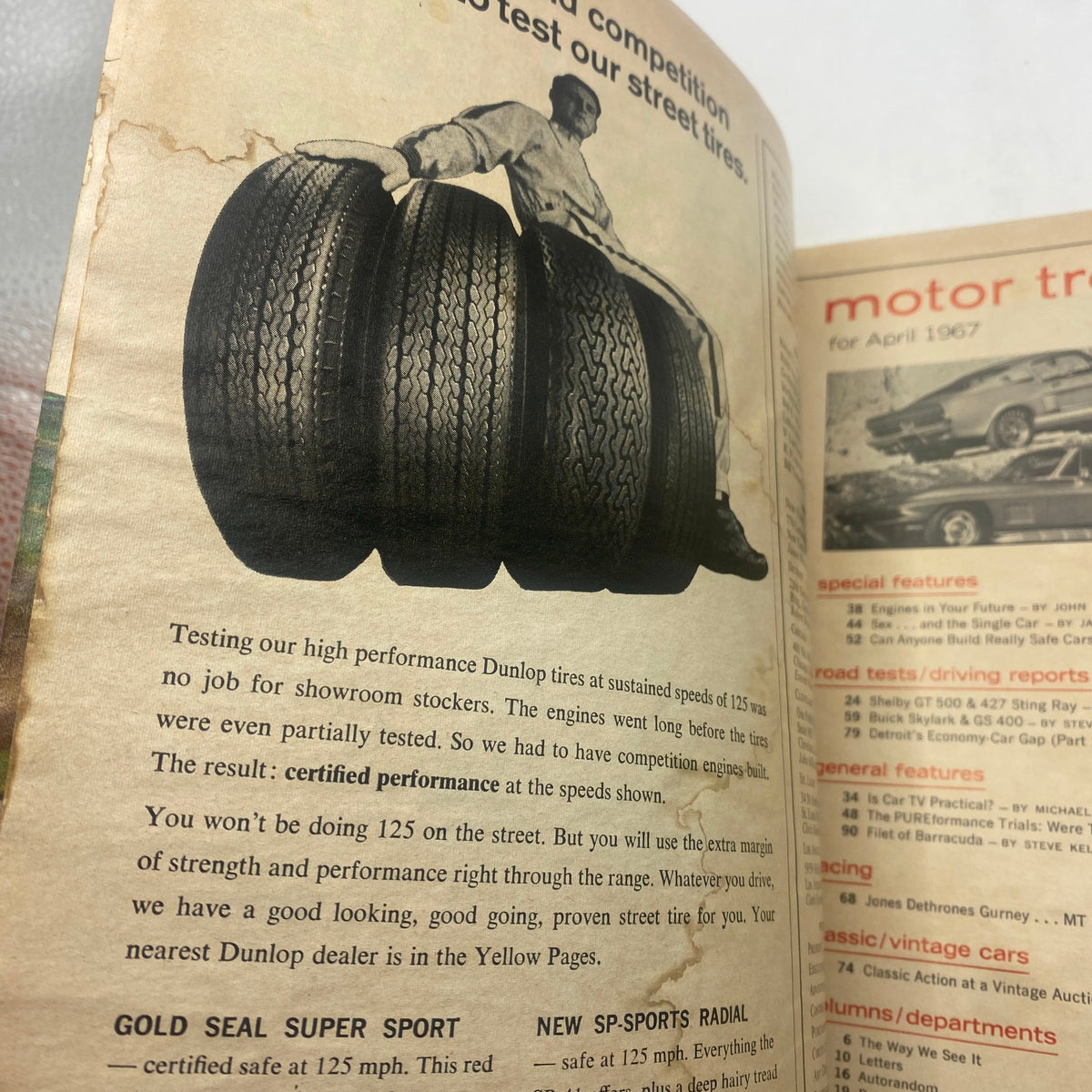 VTG Motor Trend Magazine April 1967 showcasing Dunlop tires with a man testing their performance, highlighting the theme of automotive excellence.