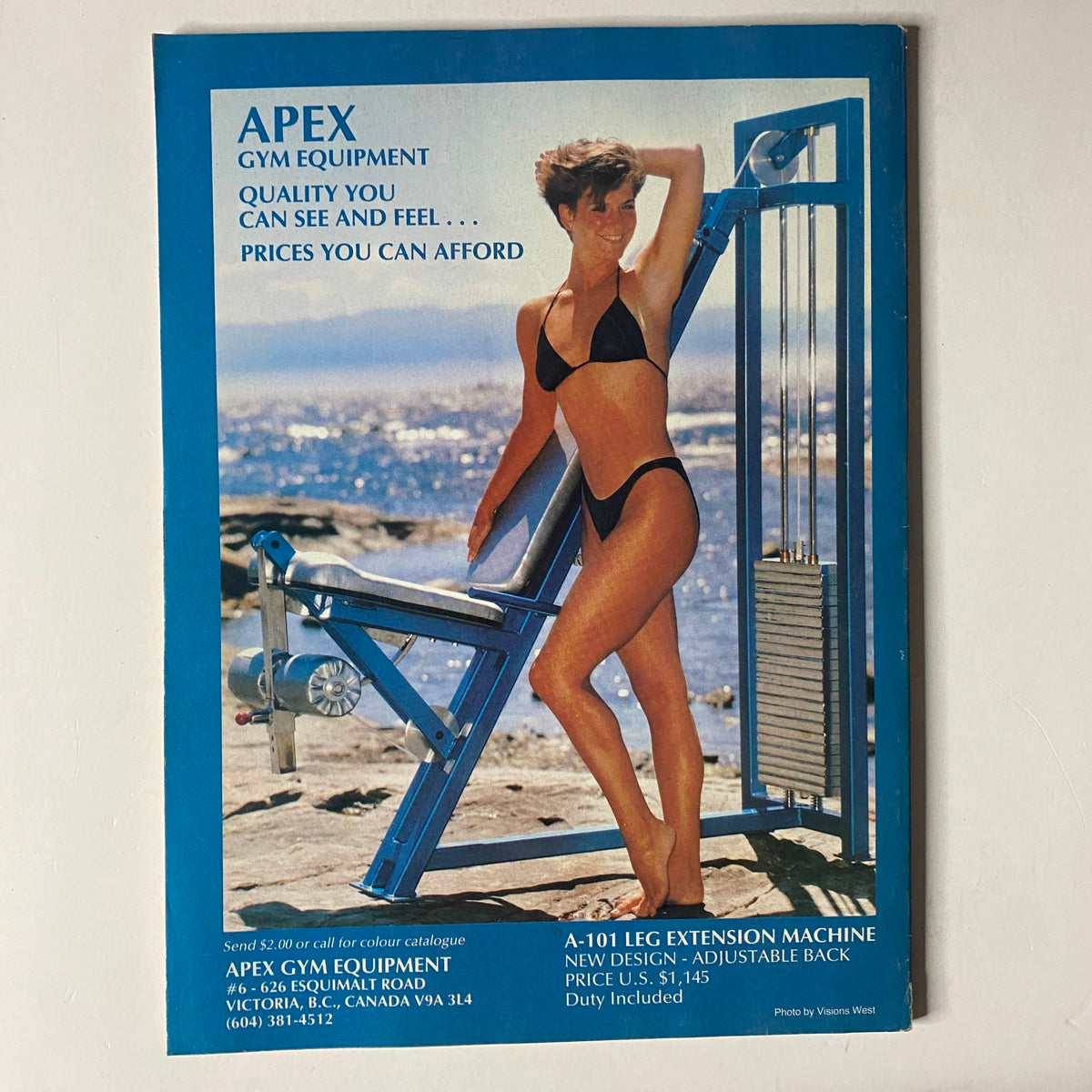 Advertisement for APEX gym equipment on the back cover of MuscleMag International Magazine, February 1989, No. 81, featuring a model next to a leg extension machine.