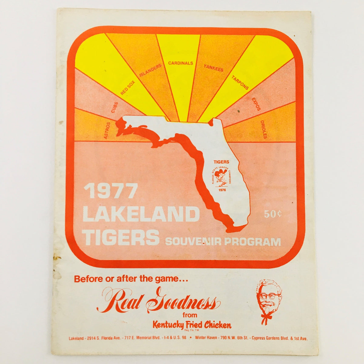 1977 MLB Baseball Lakeland Flying Souvenir Program featuring a colorful design with the state of Florida and team logos, showcasing the Lakeland Tigers. The program is in good condition with minor wear, protected by a plastic covering.