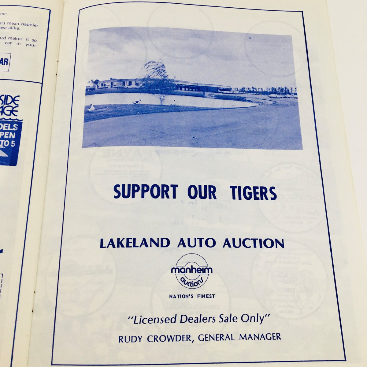 Business advertisement for Lakeland Auto Auction from the 1977 MLB Baseball Lakeland Flying Souvenir Program promoting support for the Lakeland Tigers.