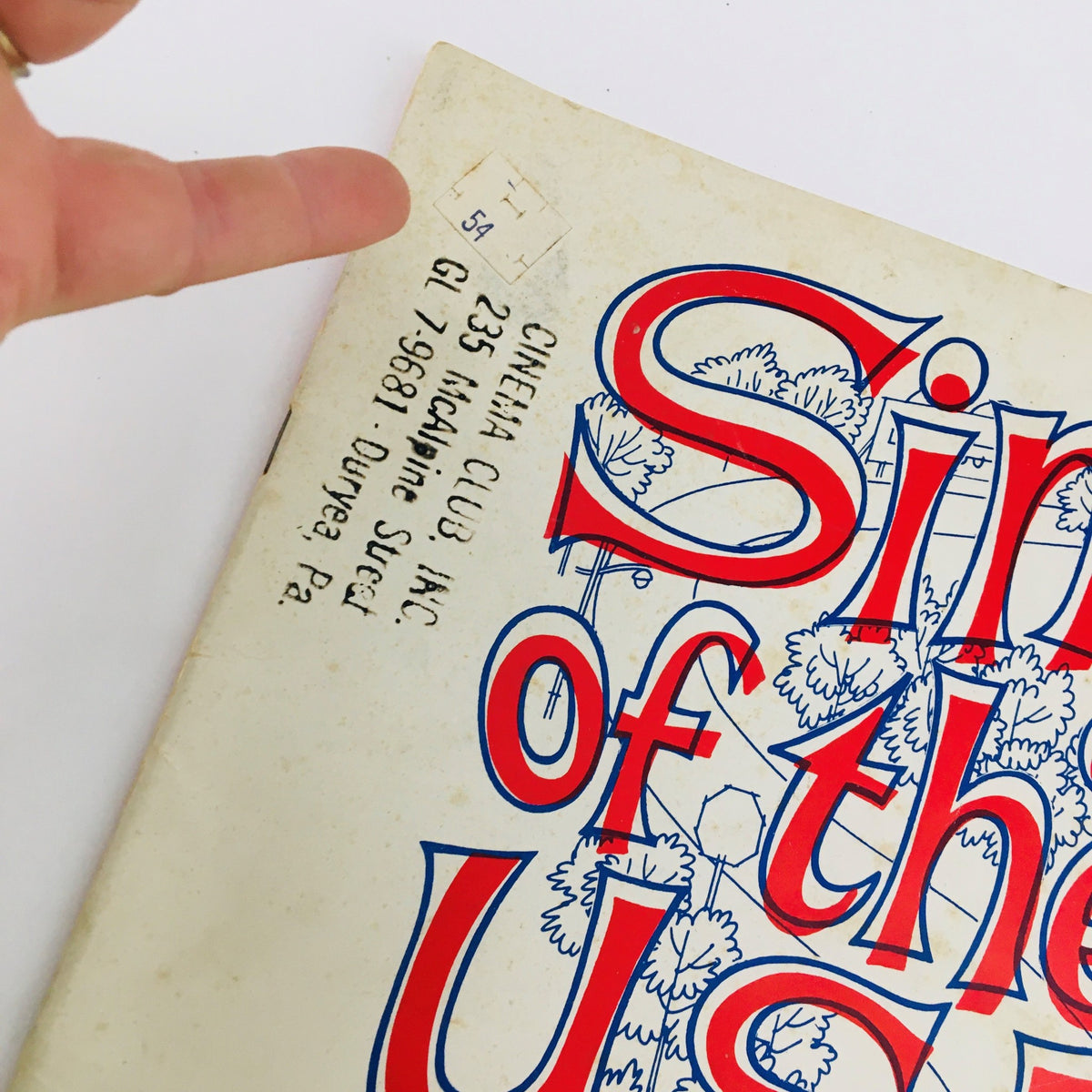 Close-up detail of the 1964 Sing of the U.S.A. with Chevrolet Song Book showing the top corner with a price sticker, emphasizing its vintage character.