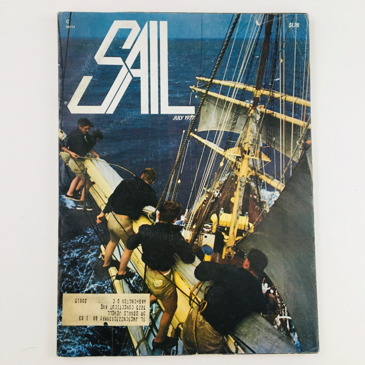 Cover of Sail Magazine July 1977 featuring a captivating sailing scene with crew working on a ship's mast, reflecting the adventurous spirit of sailing.