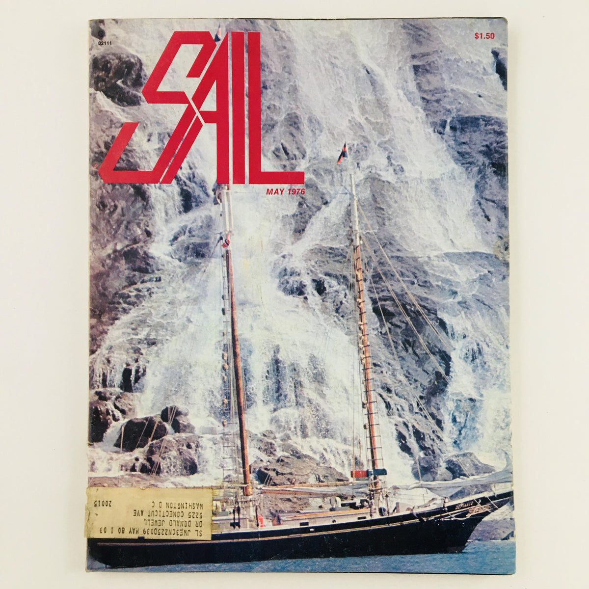 Cover of Sail Magazine May 1976 featuring the Murray Peterson-Designed Defiance Schooner amid a scenic backdrop of rocks and water.