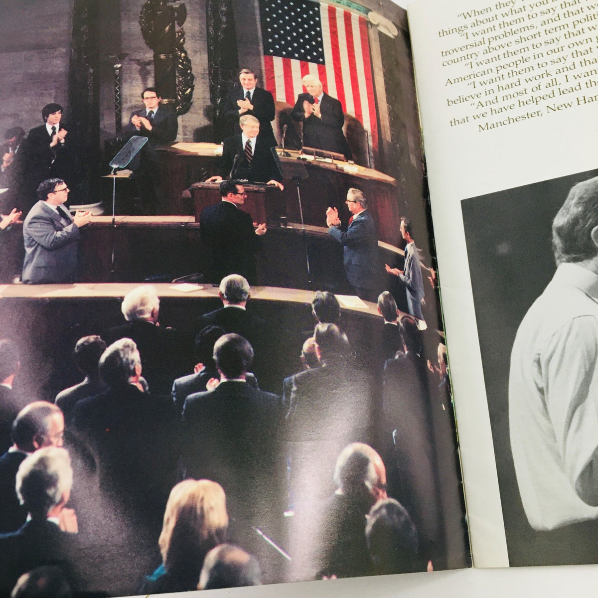 A scene from 'A New Foundation For America: Jimmy Carter The 39th President of the United States' showing Jimmy Carter speaking with an American flag in the background, surrounded by applauding audience members.