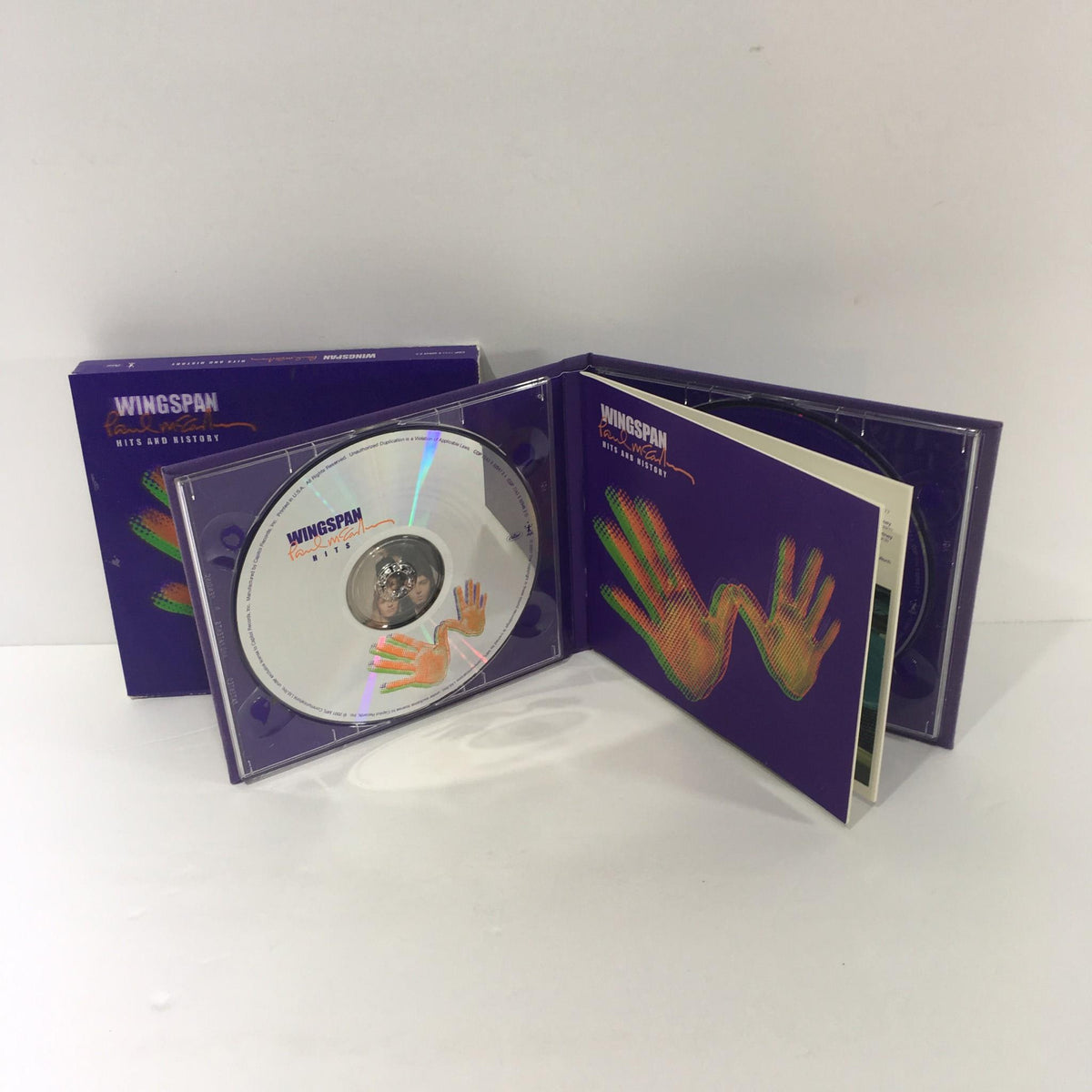 Open view of Paul McCartney Wingspan Hits and History Audio CD with disc and booklet visible.