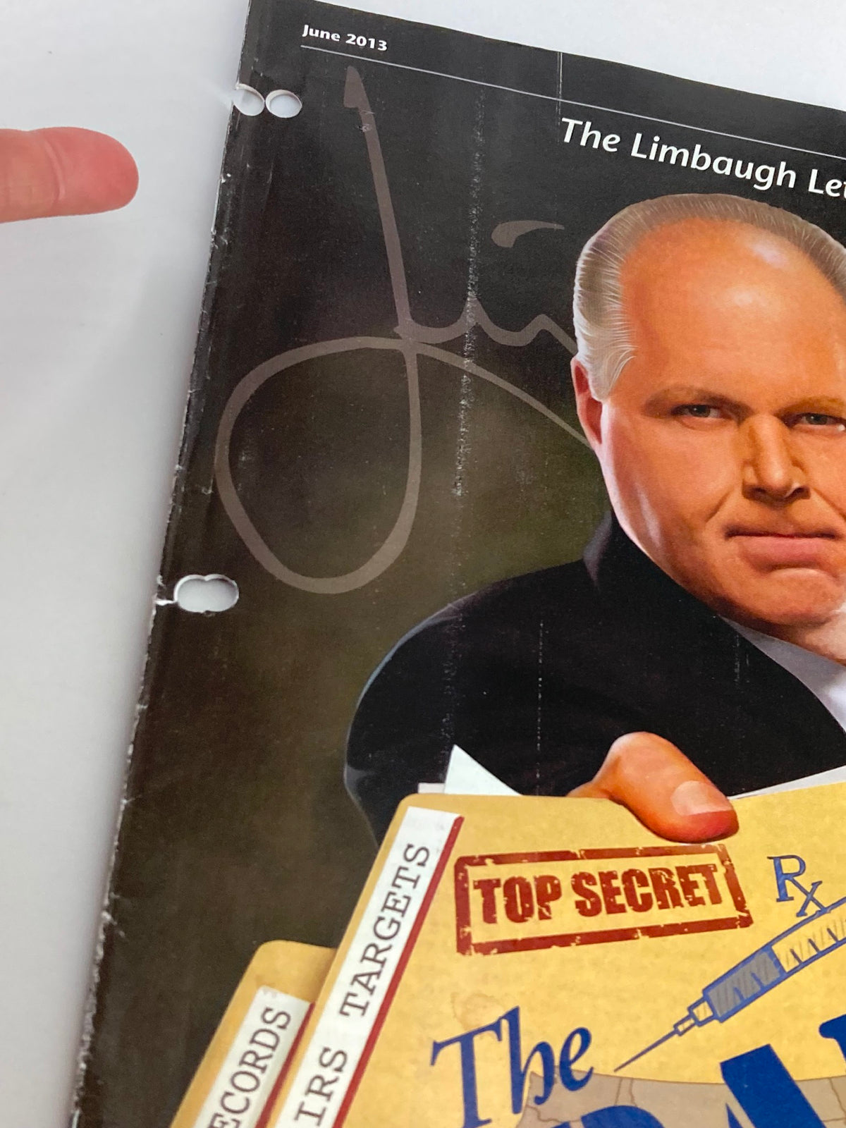Close-up view of the Rush Limbaugh Letter Newsletter Magazine from June 2013 showing Limbaugh's signature and details of the cover, highlighting the magazine's collectible nature and historical significance.