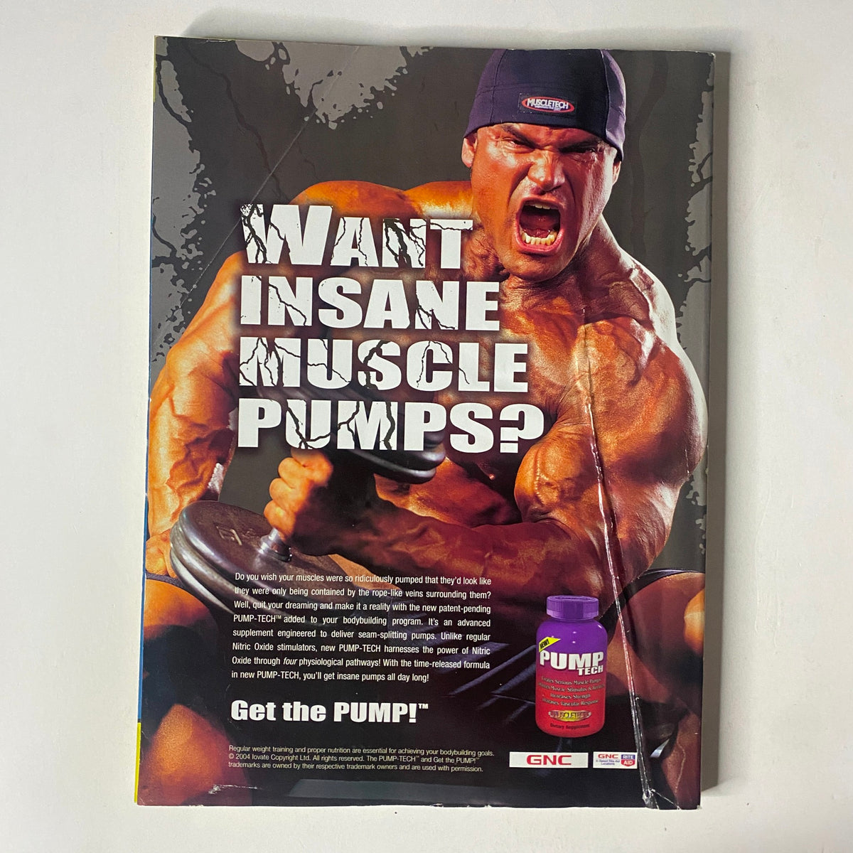 Back cover of MuscleMag International Magazine January 2005 promoting a muscle supplement with a muscular man demonstrating strength.