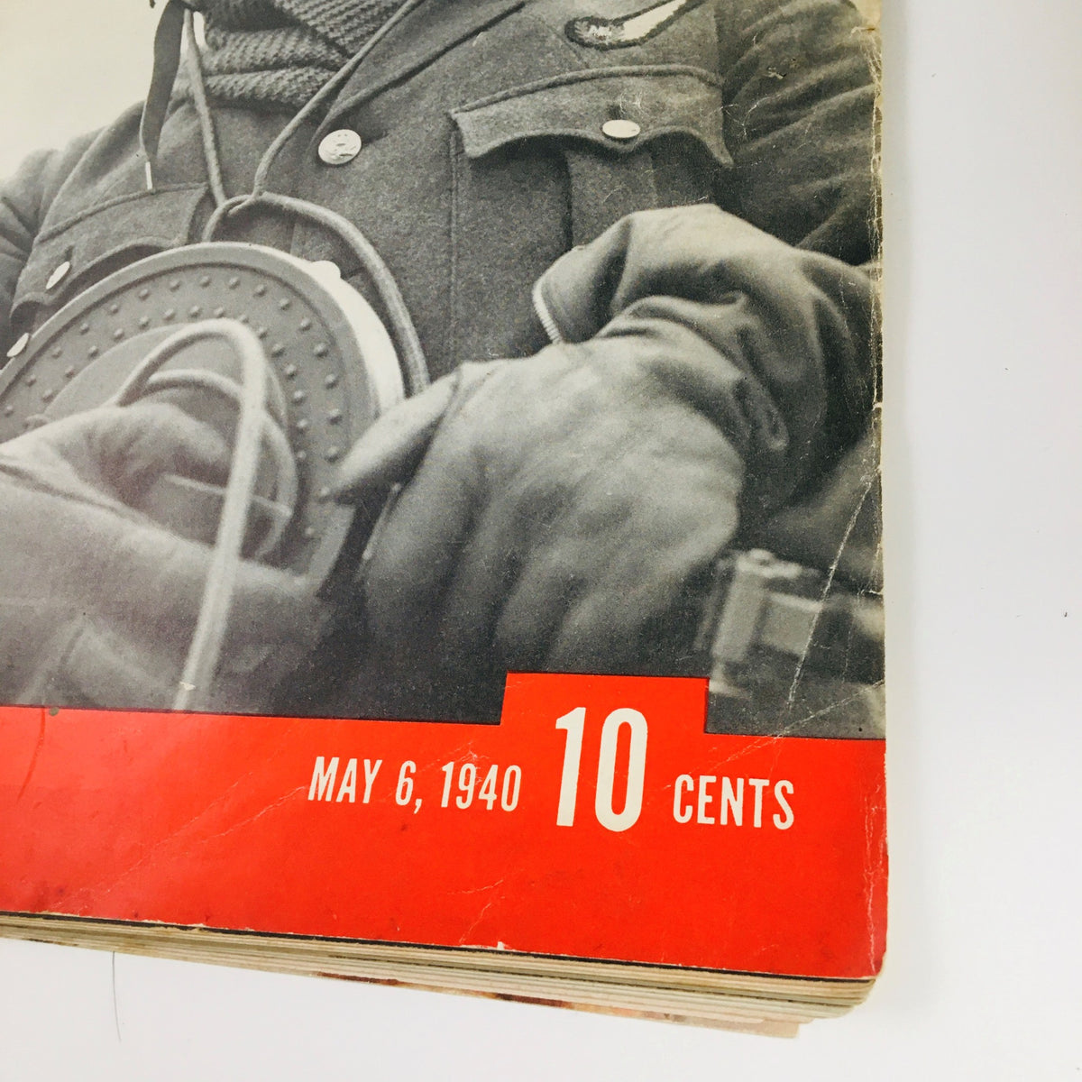 Detail shot of the cover of VTG Life Magazine May 6, 1940, focusing on the aerial gunner's hands holding military equipment, along with the magazine's date and price.