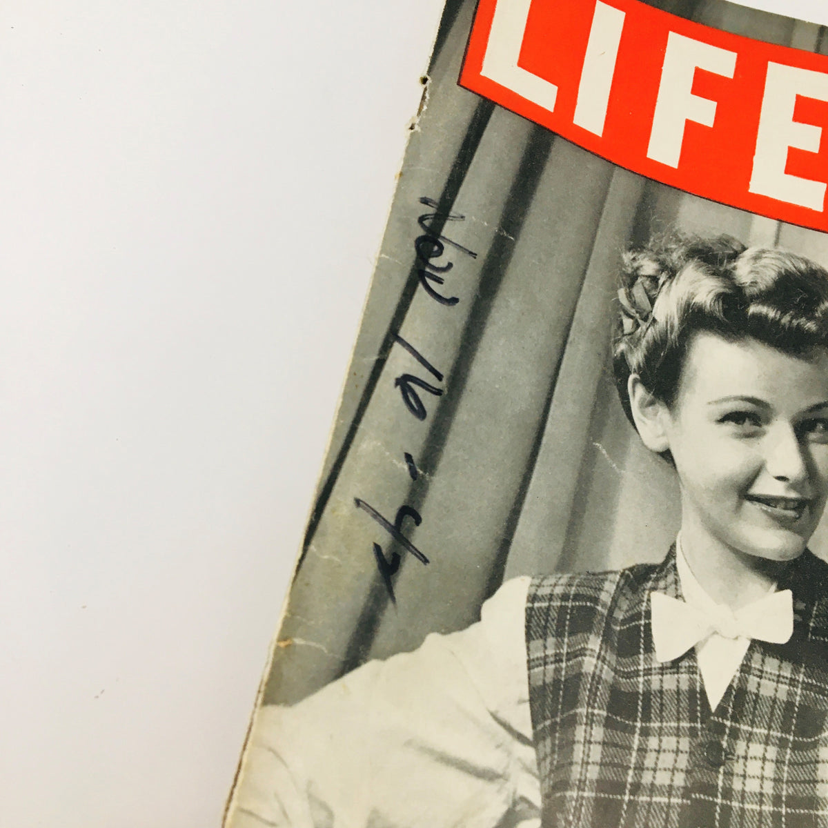 Close-up of the Life Magazine November 16, 1942 cover featuring a woman smiling, highlighting the vintage style and historical significance.
