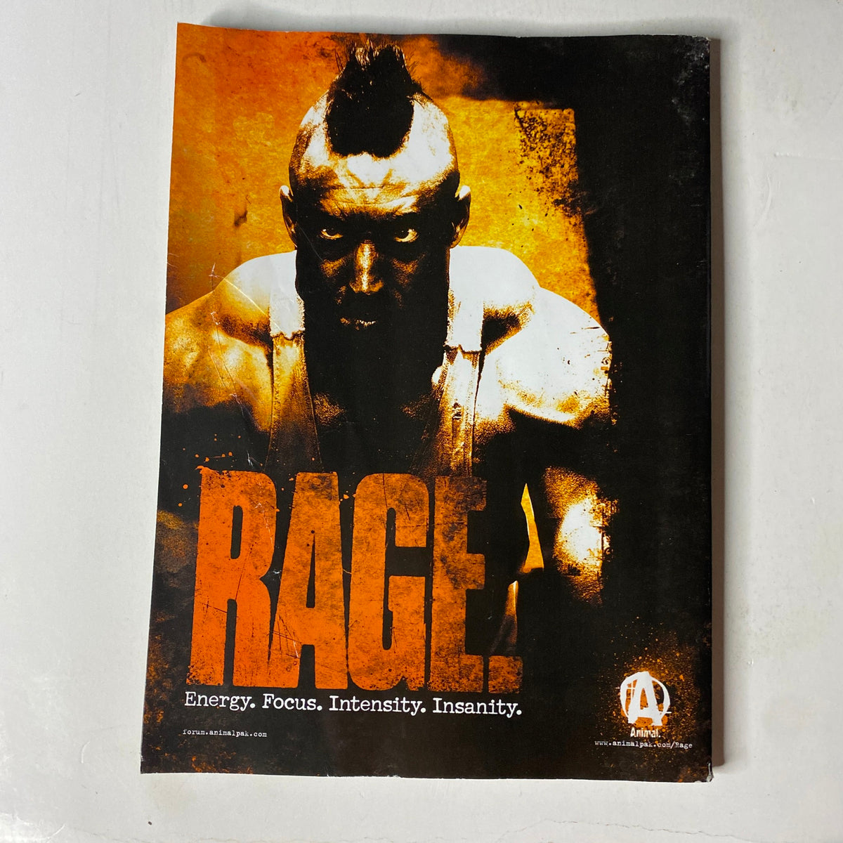 Advertisement page in MuscleMag International Magazine May 2011, Issue #348 for a product called 'RAGE' focusing on energy and fitness intensity.