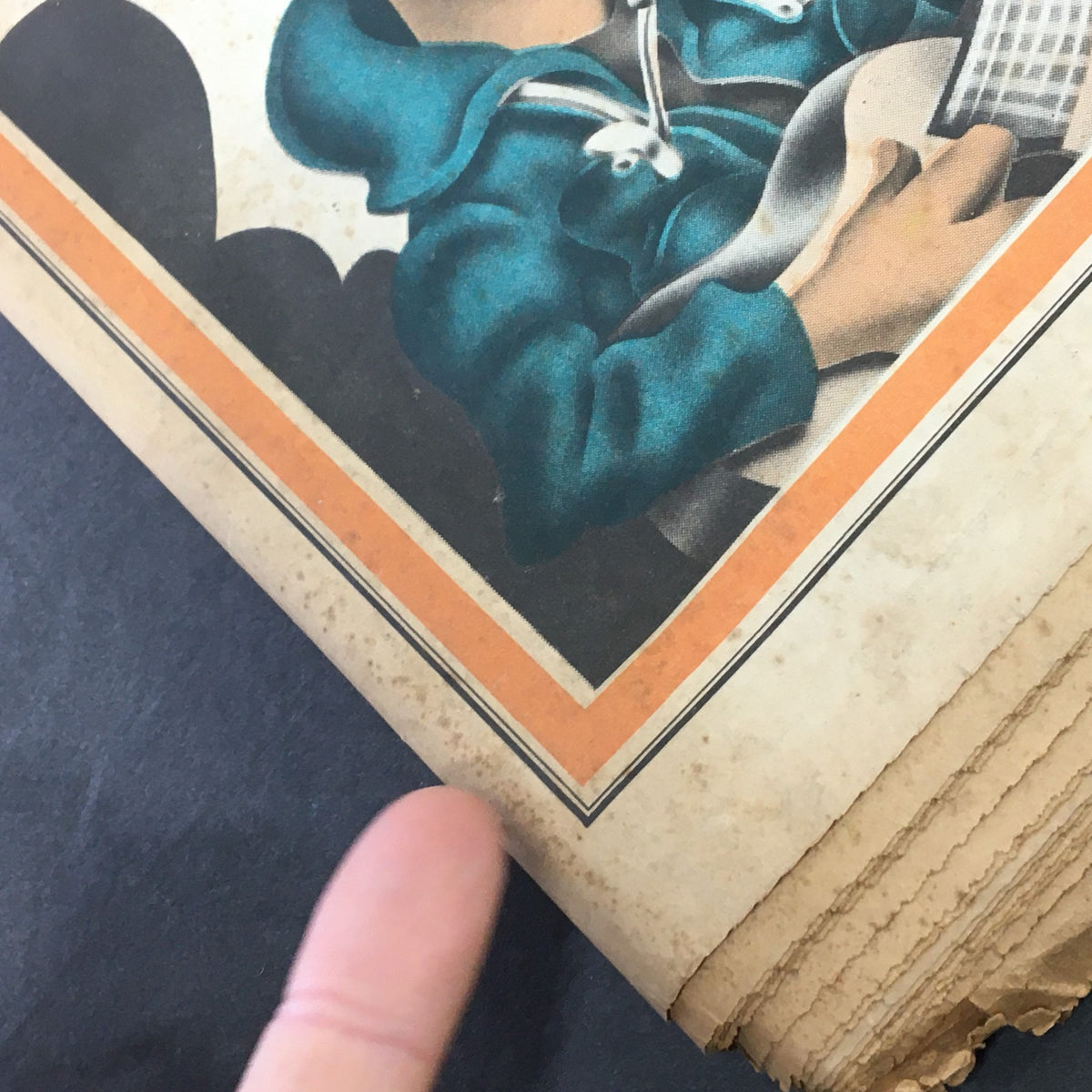Detailed focus on the lower part of the VTG Rolling Stone Newspaper March 16 1972 #104 cover with Bob Dylan's caricature, showing a finger pointing to the artwork and the condition of the magazine.