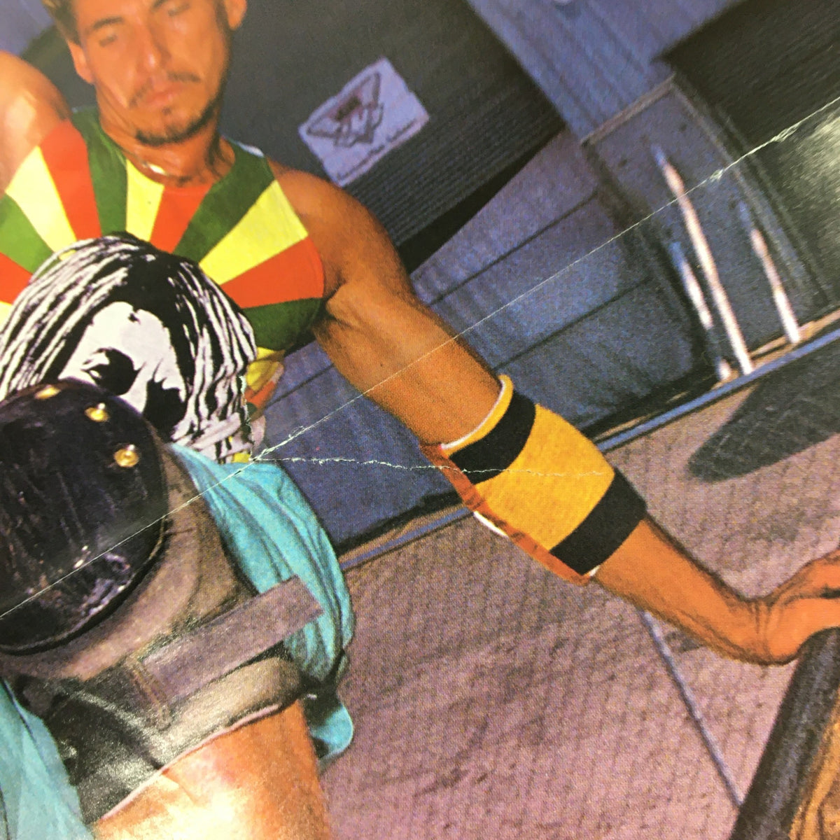 Detailed shot of a skateboarder in Transworld Skateboarding Magazine April 1989, highlighting vibrant clothing and skateboard safety gear.
