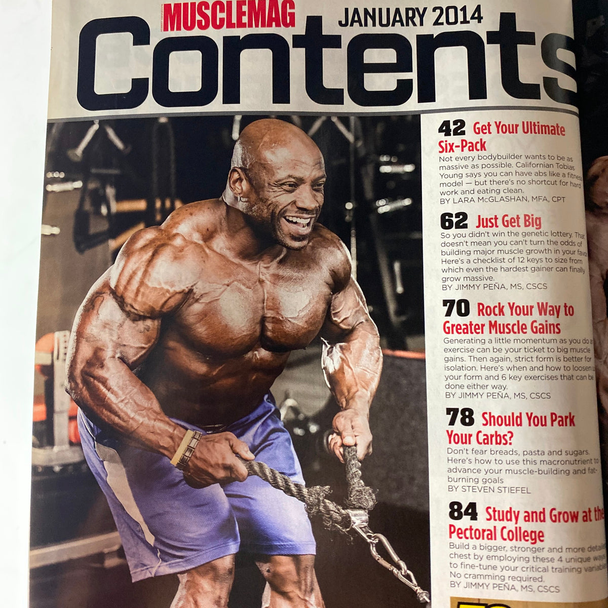 Contents page of MuscleMag International Magazine January 2014, highlighting articles on muscle gains, six-pack tips, and workouts.
