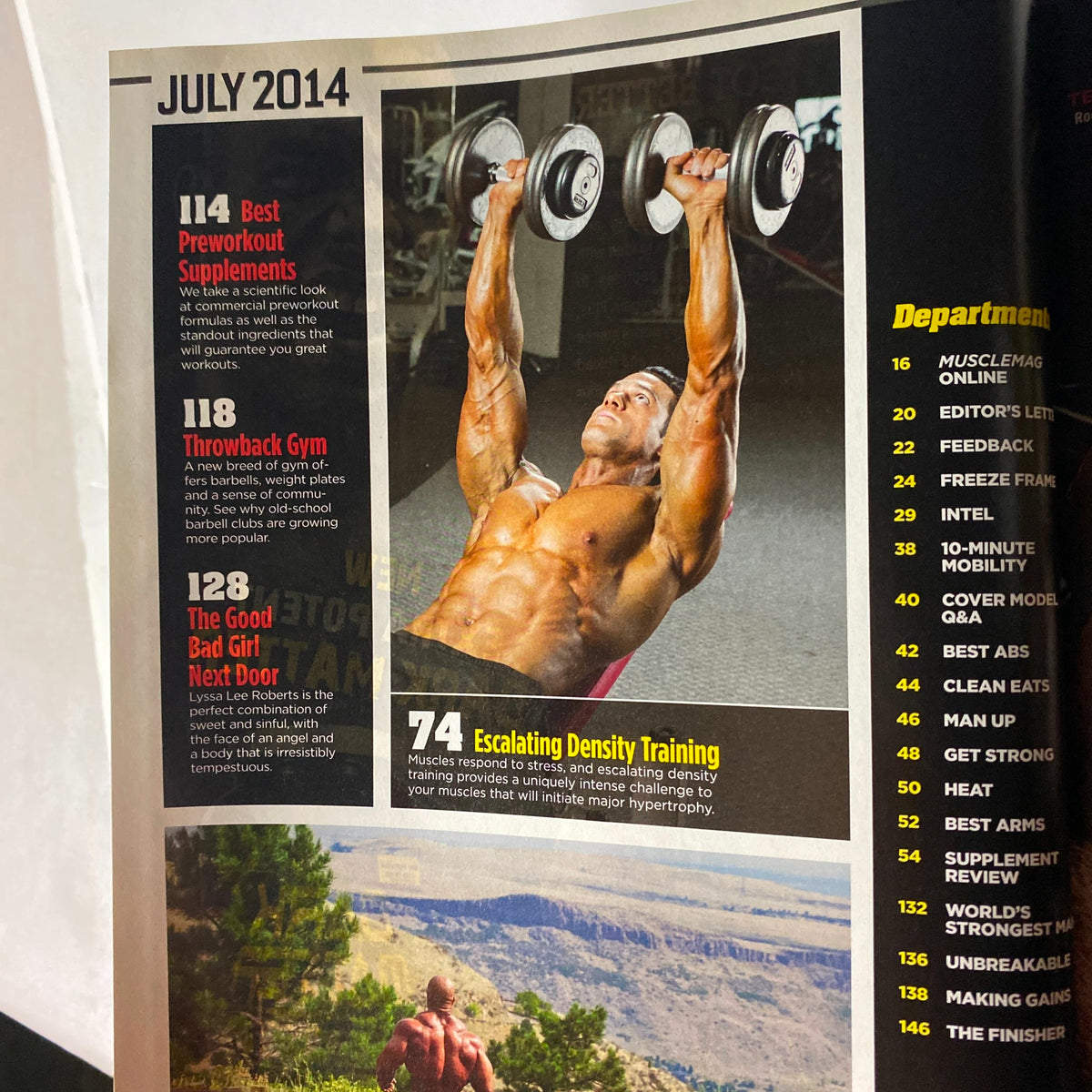 Highlighted page from MuscleMag International Magazine July 2014 featuring training insights, including pre-workout supplements and a focus on escalating density training, accompanied by a muscular model demonstrating exercise.