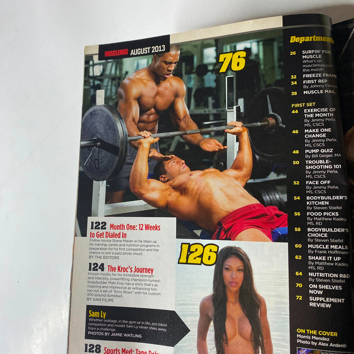 MuscleMag International Magazine August 2013 page showcasing bodybuilding exercises, including men lifting weights, along with highlights on fitness journeys and profiles.
