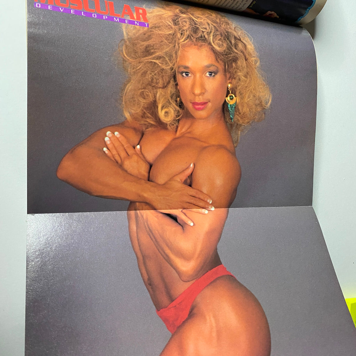 Centerfold poster of Laura Creavalle from Muscular Development Magazine June 1990, displaying her strength and beauty in an artistic pose.