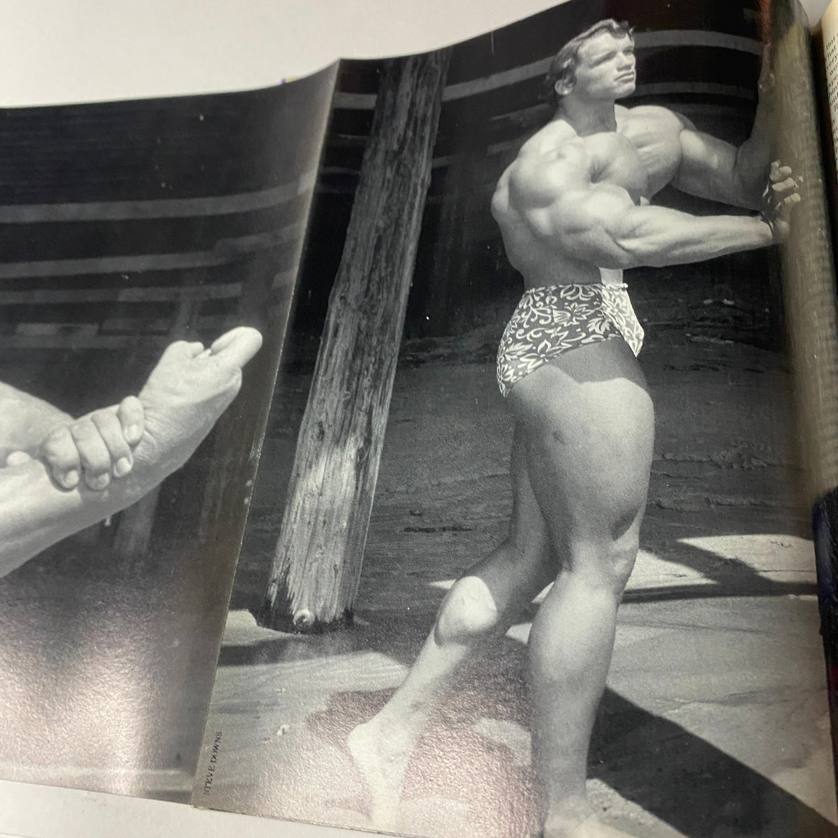 Muscular Development Magazine July 1990 featuring a black and white photograph of a muscular bodybuilder posing on a beach, showcasing classic bodybuilding aesthetics in very good condition.