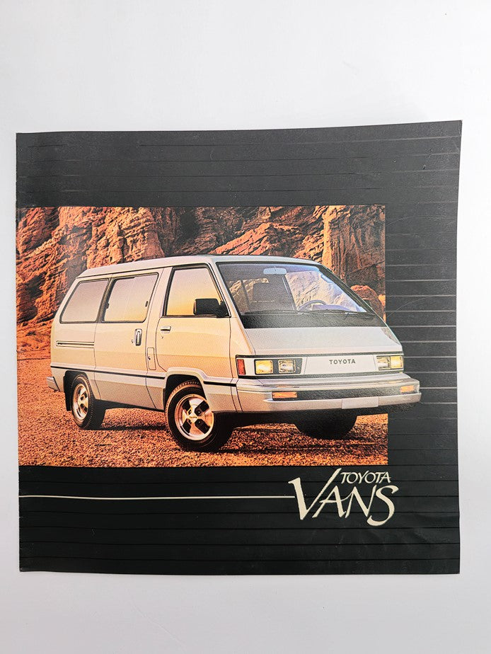 1984 Toyota Vans Car Sale Catalog Brochure featuring a Toyota van on a scenic backdrop, showcasing the vehicle's exterior design and branding.