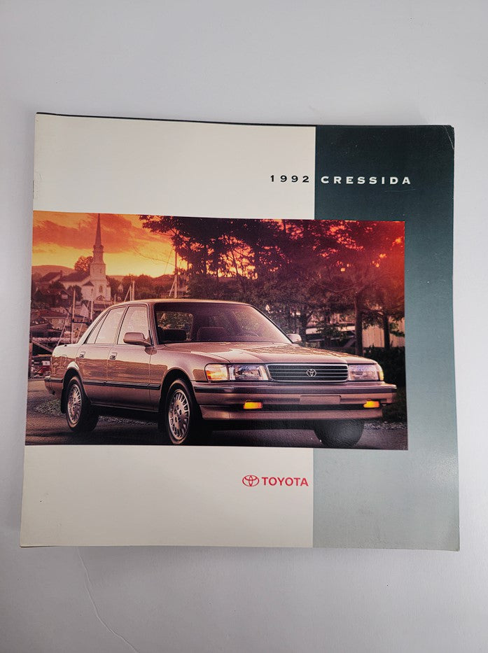 1992 Toyota Cressida Sedan Compact Car Sale Catalog Brochure featuring a front view of the car in an outdoor setting with a sunset background.