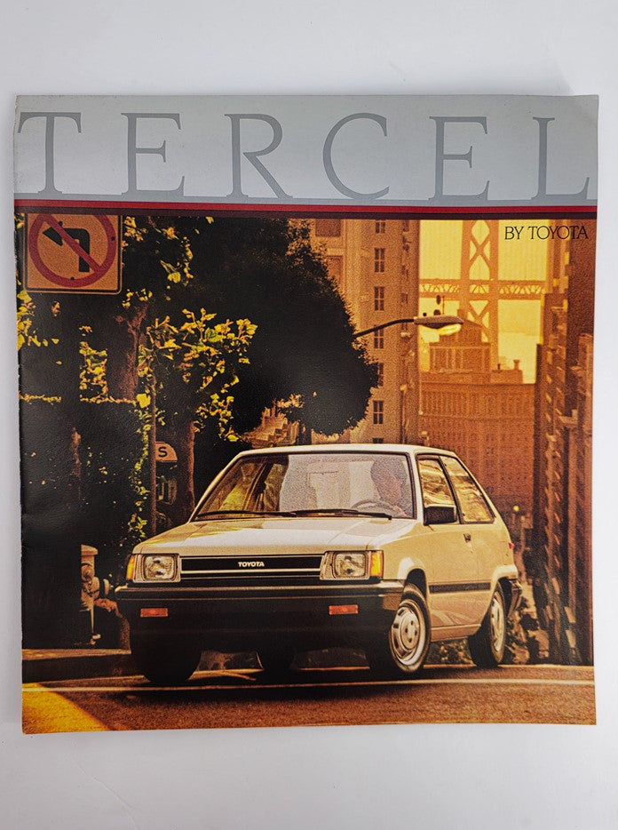1986 Toyota Tercel Car Sale Catalog Brochure showcasing a white Toyota Tercel in an urban setting, emphasizing its classic design and vibrant colors.