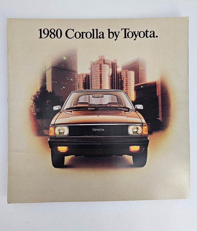 1980 Toyota Corolla E70 CS Coupe Car Sale Brochure Catalog showcasing the car's front view against an urban backdrop. This vintage catalog highlights the classic design and features of the 1980 Corolla.