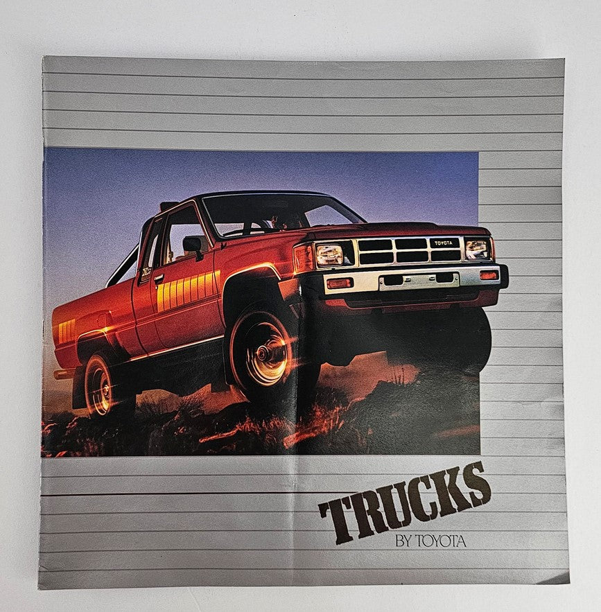Cover of the 1984 Toyota Truck Models Sale Brochure Catalog featuring a red Toyota truck under dramatic lighting against a sunset backdrop.