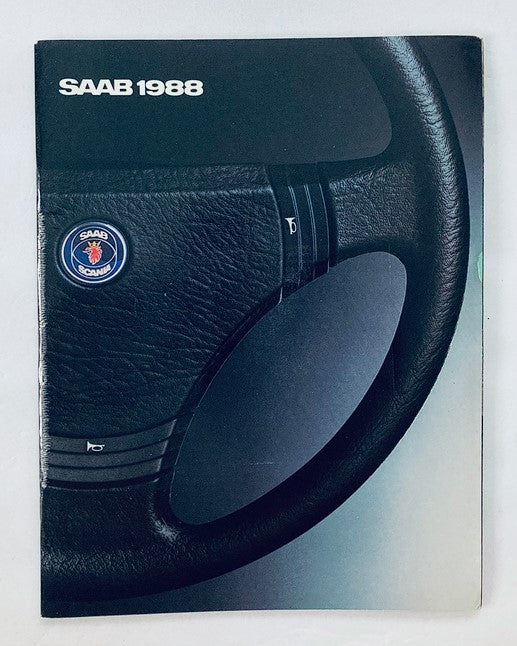 Cover of the 1988 Saab Car Dealer Showroom Sales Brochure Guide Catalog, showcasing a close-up of a Saab steering wheel with the emblem and title 'SAAB 1988' prominently displayed.