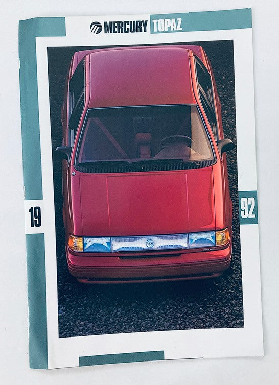 1992 Mercury Topaz Dealer Showroom Sales Brochure Guide Catalog featuring a top view of a red Mercury Topaz car on a gravel surface. This brochure provides insights into the features and specifications of the 1992 model.